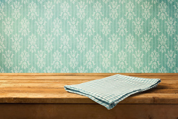tablecloth on wooden table over retro wallpaper