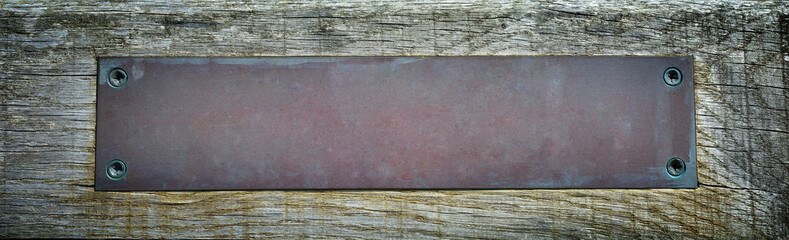 Metal plate on wooden background