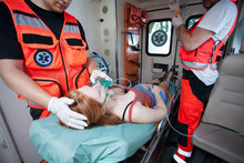 Unconscious Woman And Working Paramedics