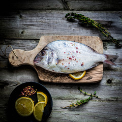 Wall Mural - Fresh sea bream on wooden board