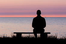 Silhouette Of Man On Bench