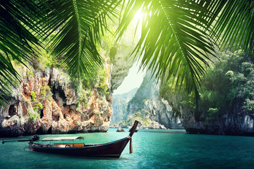 Wall Mural - long boat and rocks on beach in Krabi, Thailand