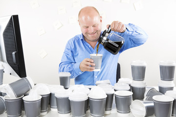 Wall Mural - Smiling businessman drinks too much coffee