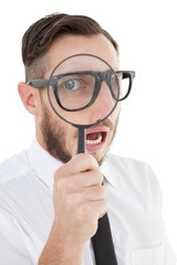 Poster - Nerdy businessman looking through magnifying glass
