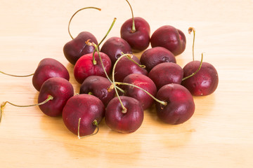 Wall Mural - Red Cherries on a Wood Table