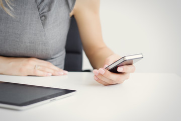  Businesswoman using mobile phone while sitting at desk