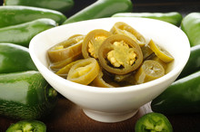 Pickled Sliced Green Jalapeno Peppers In White Bowl