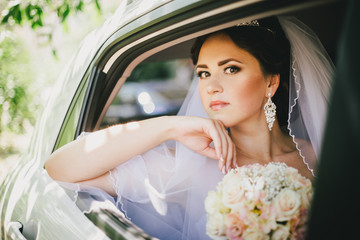 Beautiful bride in a car