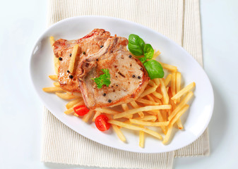 Canvas Print - Pan fried pork chop with fries