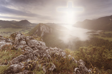 Cross int he sky seen on top of the mountain