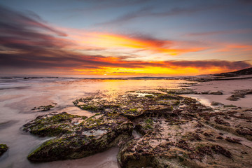 beautiful beach rock under sunset