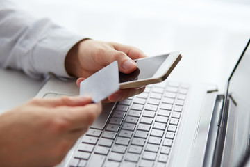 Man with mobile phone and credit card payment