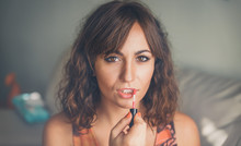 Attractive Woman Applying Lipstick Or Lip Gloss