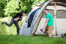 Couple Trying To Pitch A Tent