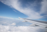 Fototapeta Niebo - Wing of an airplane flying in the sky so beautiful.