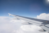 Fototapeta Niebo - Wing of an airplane flying in the sky so beautiful.