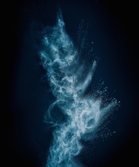 Wall Mural - blue powder exploding isolated on black