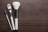 Fototapeta Sypialnia - white make-up brushes on brown background