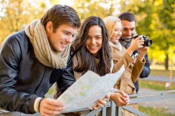 Poster - group of friends with map and camera outdoors