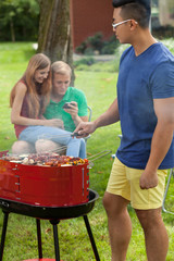 Canvas Print - Young friends during barbecue