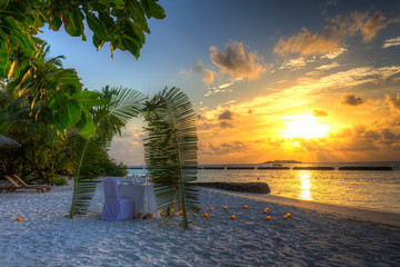 Wall Mural - Dinner at the beach by sunset