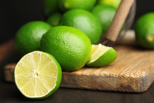 Fresh Juicy Limes On Wooden Table, On Dark Background