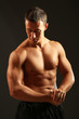 © Africa Studio - Handsome muscle young man on dark background