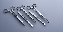 Surgical Instruments On A Blue-gray Background