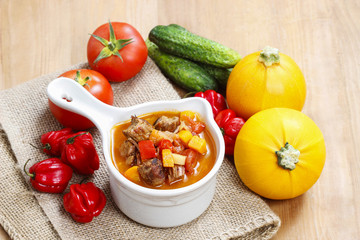 Canvas Print - Bowl of goulash soup and fresh vegetables