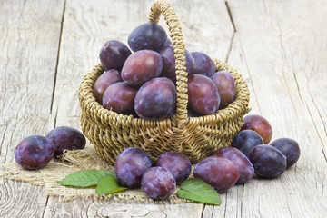 Wall Mural - fresh plums in a basket