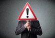 © ra2 studio - Businessman holding an exclamation road sign
