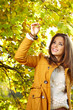 © ZoomTeam - Beautiful elegant woman standing in a park in autumn