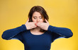 Woman covering closed mouth. Speak no evil concept