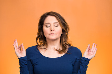 Woman relaxing, meditating, in zen mode orange background 