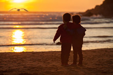 Beautiful Picture Of Two Boys On The Beach At Sunset