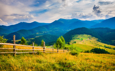 Wall Mural - amazing mountain landscape with fog and a haystack