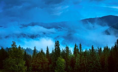 Wall Mural - amazing mountain landscape with fog and a haystack