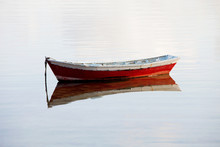 Lone Red Boat Floating