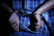 © Africa Studio - Criminal hands locked in handcuffs on dark background