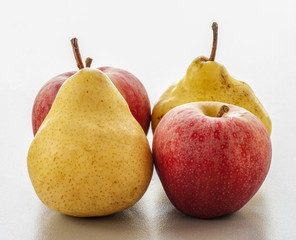 ripe pear and apple on a white background close-up