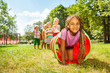 © Sergey Novikov - African girl play crawling through tube in park
