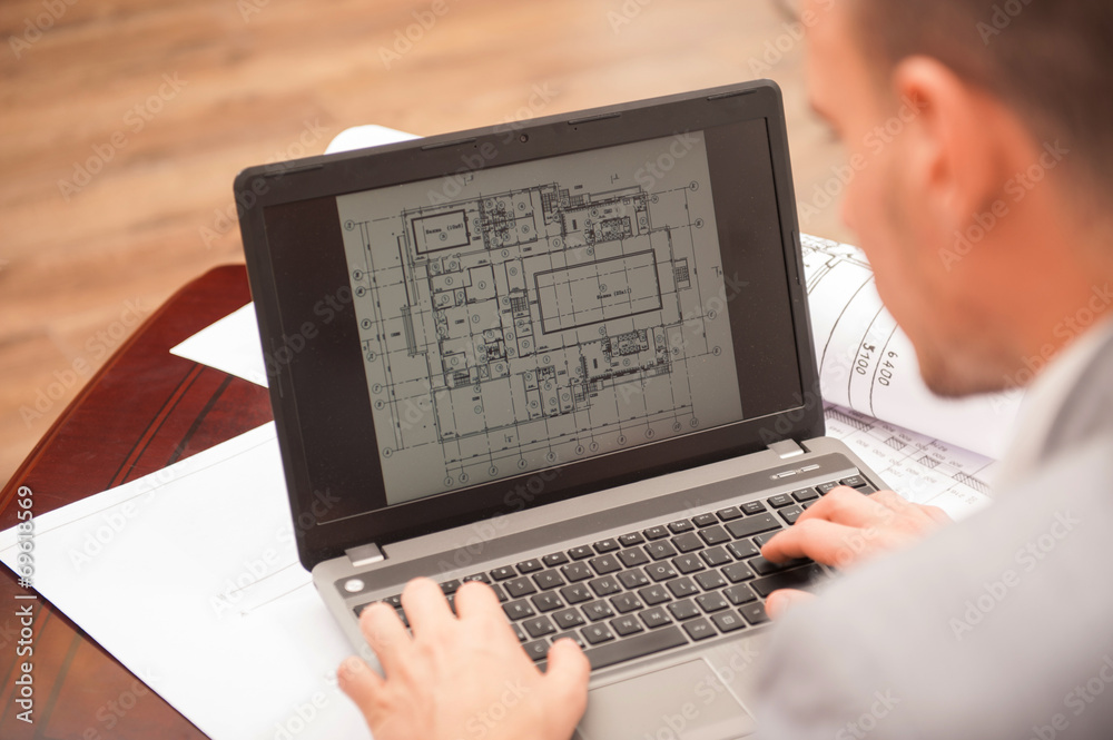 Close-up portrait of laptop with blueprints - obrazy, fototapety, plakaty 