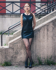 Pretty goth girl posing in urban landscape