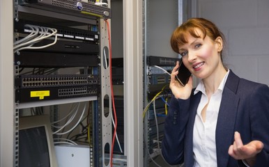 Aufkleber - Pretty computer technician talking on phone beside open server