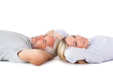 Poster - Smiling couple lying and looking at camera