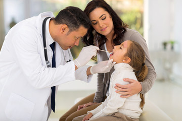 Wall Mural - pediatric doctor examining little patient