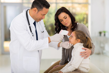 Wall Mural - pediatric doctor measuring temperature of little patient