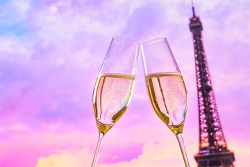 Wall Mural - champagne flutes on sunset blur tower Eiffel background