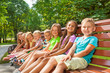 © Sergey Novikov - Happy children sit on the bench in park