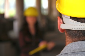 A young attractive man and woman construction team on work site